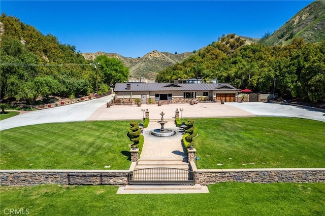 view of front facade with a front yard and a mountain view
