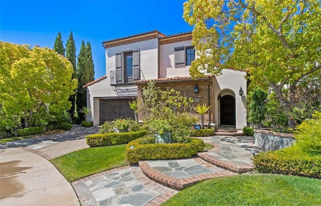 21 Observatory, Newport Coast, CA 92657 - mediterranean / spanish house with stucco siding, an attached garage, driveway, a balcony, and a tiled roof