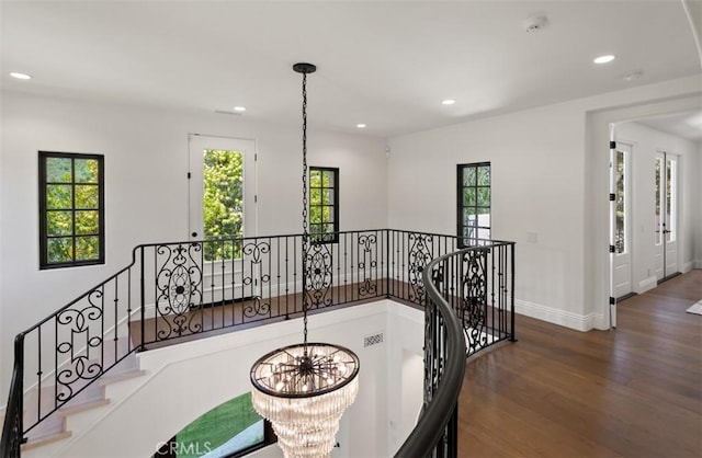 hall featuring a wealth of natural light, wood finished floors, and recessed lighting