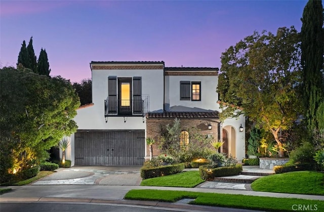 21 Observatory, Newport Coast, CA 92657 - mediterranean / spanish-style house featuring a garage, driveway, stucco siding, a balcony, and a tile roof