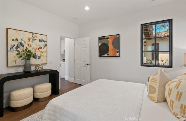 bedroom featuring dark wood-type flooring and recessed lighting