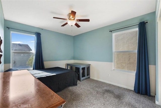 unfurnished bedroom featuring baseboards, a ceiling fan, and carpet floors