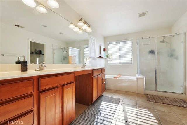 full bathroom with a stall shower, visible vents, a sink, tile patterned floors, and double vanity