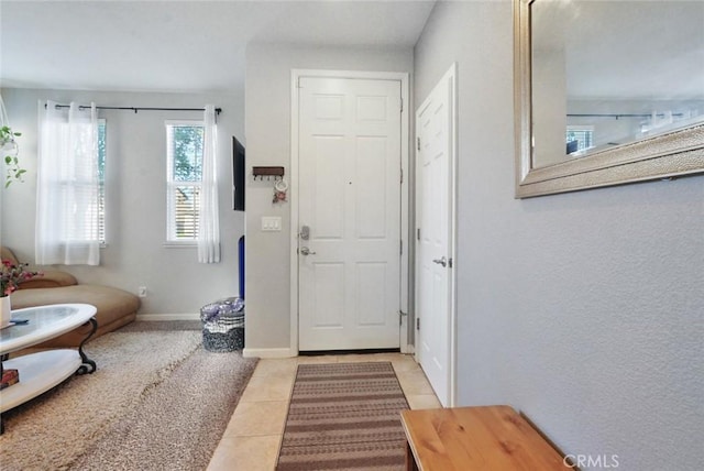 entrance foyer featuring baseboards and light tile patterned flooring