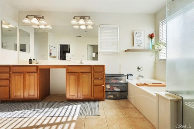 bathroom with a sink, tile patterned floors, double vanity, and a garden tub