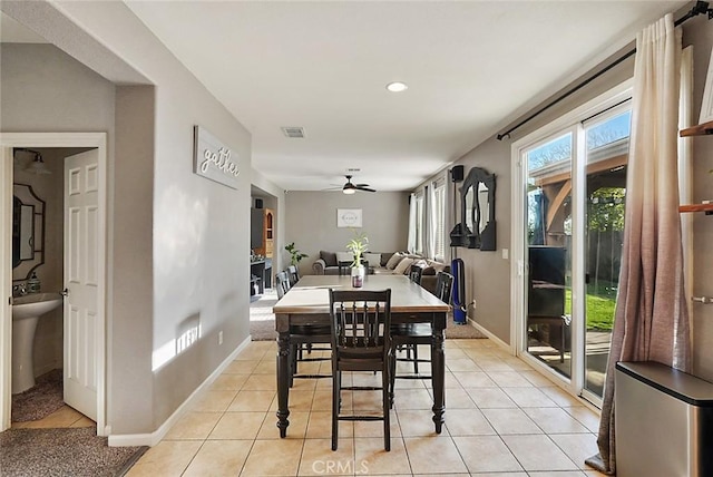 dining space with light tile patterned floors, baseboards, a ceiling fan, and visible vents