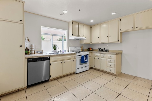 15767 San Roque Rd, Fontana, CA 92337 - kitchen featuring cream cabinets, stainless steel dishwasher, white range with gas stovetop, a sink, and recessed lighting
