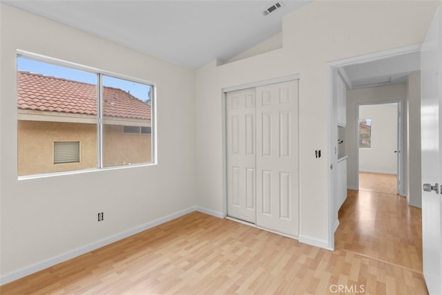 15767 San Roque Rd, Fontana, CA 92337 - unfurnished bedroom featuring light wood-type flooring, baseboards, lofted ceiling, and a closet