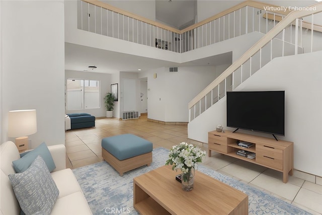15767 San Roque Rd, Fontana, CA 92337 - living room with tile patterned floors, a high ceiling, stairway, and baseboards