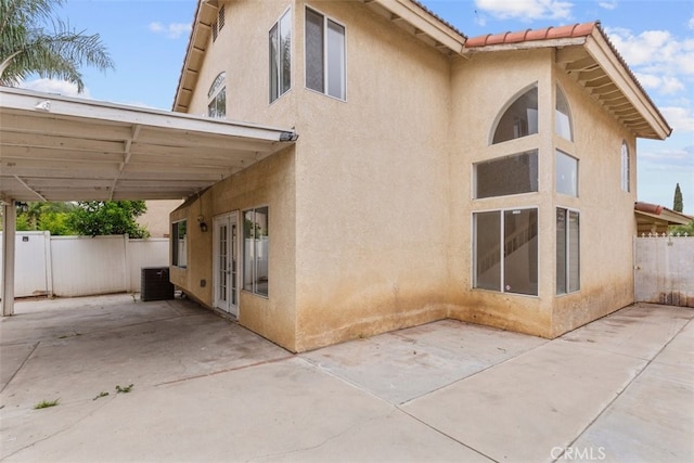 15767 San Roque Rd, Fontana, CA 92337 - rear view of property featuring stucco siding, a patio, and fence