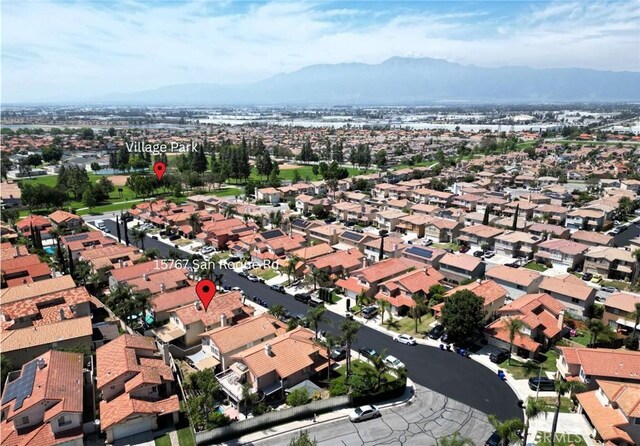15767 San Roque Rd, Fontana, CA 92337 - aerial overview of property's location featuring a mountain backdrop and nearby suburban area