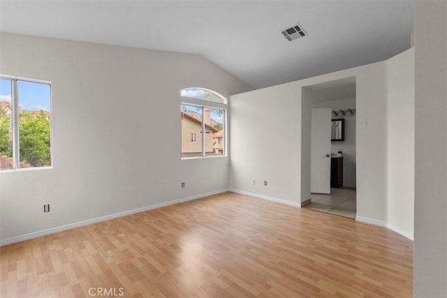 15767 San Roque Rd, Fontana, CA 92337 - spare room featuring plenty of natural light, light wood finished floors, baseboards, and vaulted ceiling