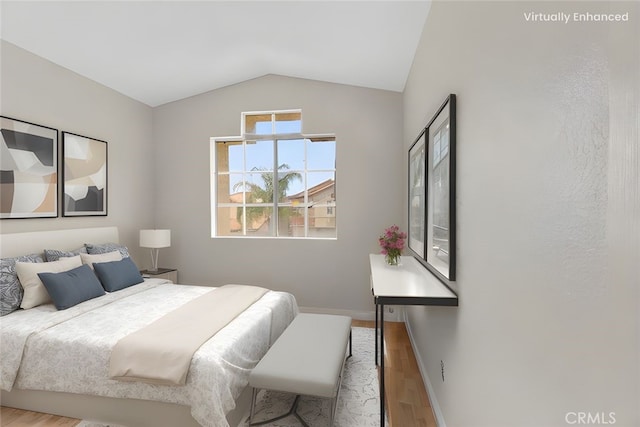 15767 San Roque Rd, Fontana, CA 92337 - bedroom featuring wood finished floors, vaulted ceiling, and baseboards