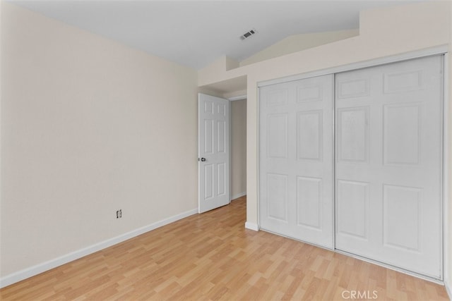 15767 San Roque Rd, Fontana, CA 92337 - unfurnished bedroom with lofted ceiling, light wood-type flooring, baseboards, and a closet