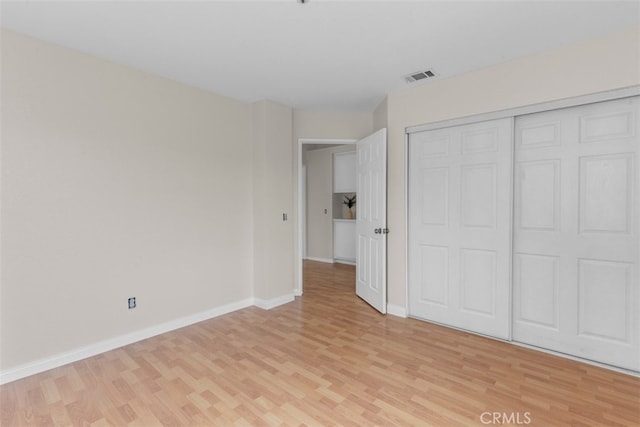 15767 San Roque Rd, Fontana, CA 92337 - unfurnished bedroom with light wood-type flooring, baseboards, and a closet