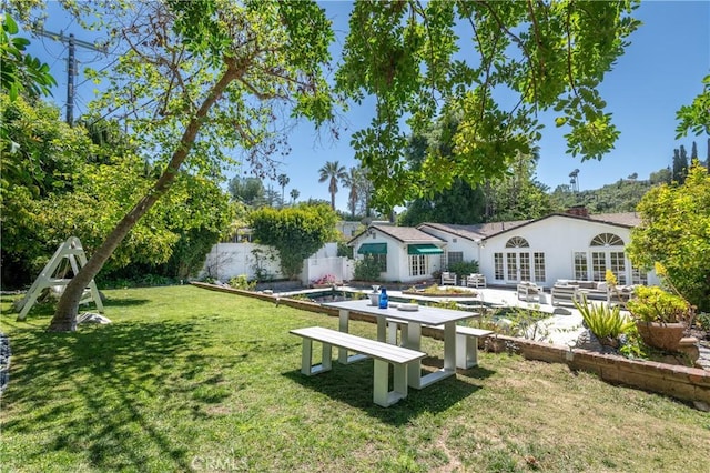 exterior space with a patio area, outdoor lounge area, fence private yard, and a lawn
