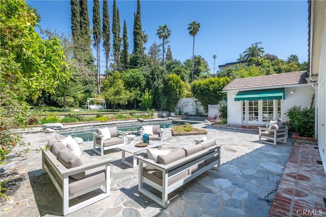 view of patio with an outdoor pool, french doors, an outdoor living space, and fence