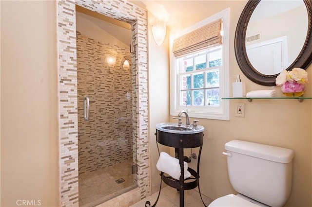 full bath with toilet, a sink, and a stall shower