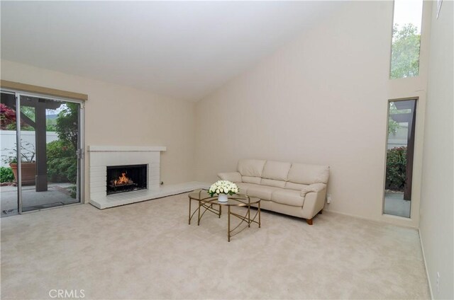 carpeted living area featuring a fireplace