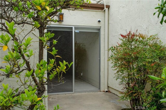 doorway to property with stucco siding