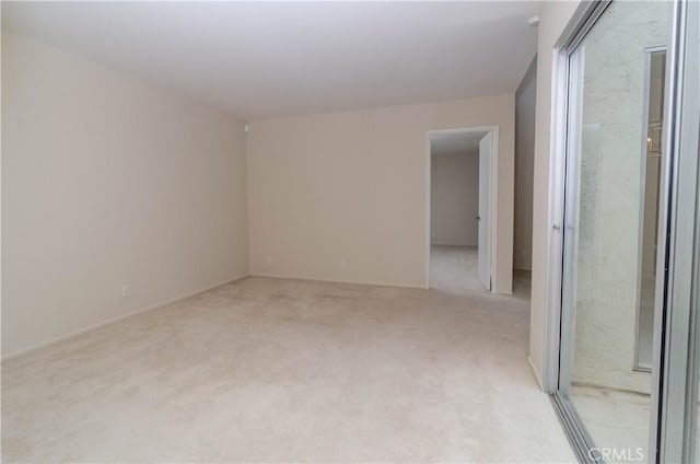 spare room featuring light carpet