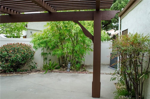 view of patio featuring a pergola, central air condition unit, and fence private yard