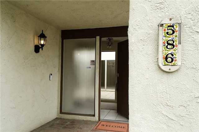 doorway to property with stucco siding