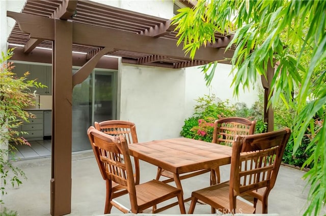 view of patio / terrace with a pergola and outdoor dining space