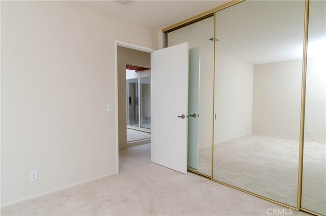 unfurnished bedroom featuring a closet and carpet floors