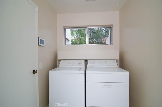 clothes washing area with independent washer and dryer and laundry area