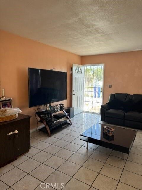 15920 Mission Ave, Fontana, CA 92335 - living room featuring a textured ceiling and light tile patterned flooring