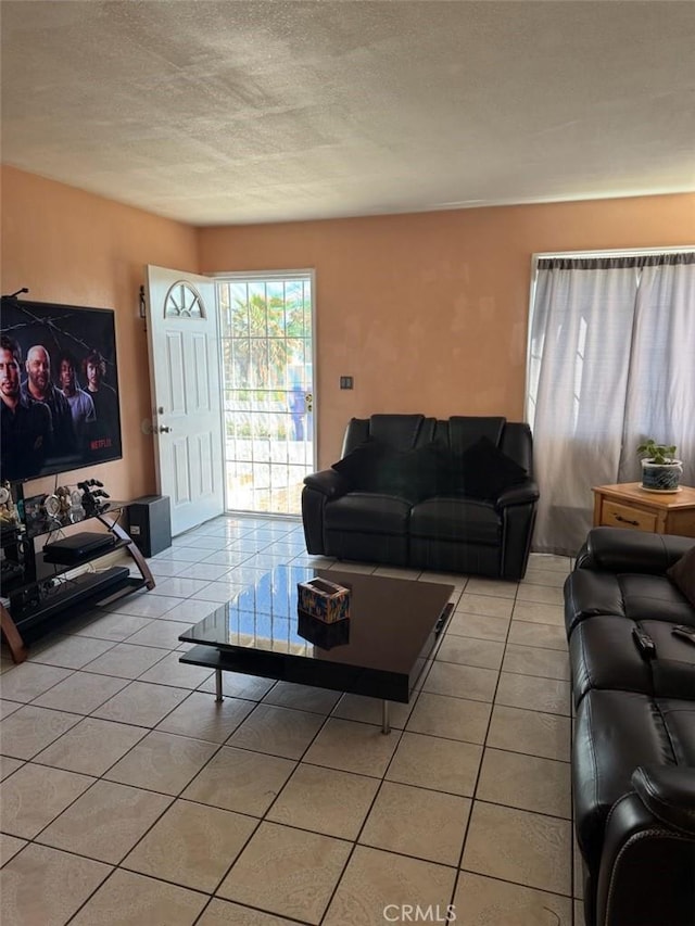 15920 Mission Ave, Fontana, CA 92335 - living room featuring light tile patterned floors and a textured ceiling