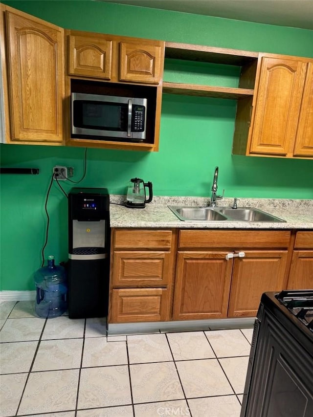 15920 Mission Ave, Fontana, CA 92335 - kitchen featuring a sink, light countertops, stainless steel microwave, and light tile patterned floors