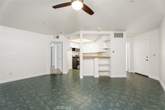 1044 Calle Del Cerro Unit 301, San Clemente, CA 92672 - unfurnished living room with ceiling fan, baseboards, and visible vents