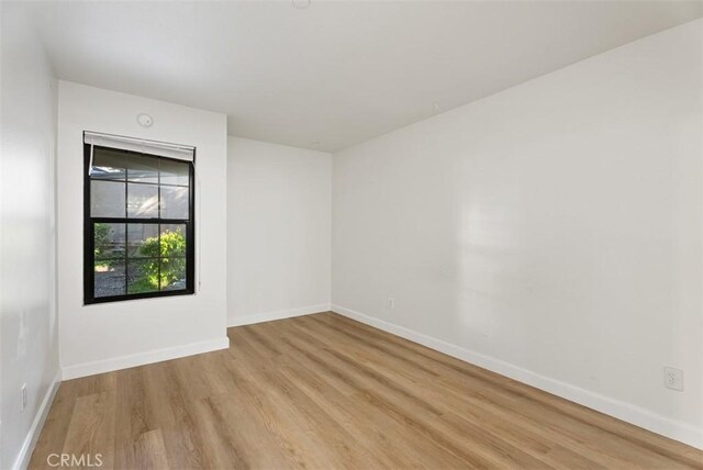 1044 Calle Del Cerro Unit 301, San Clemente, CA 92672 - empty room with light wood-type flooring and baseboards