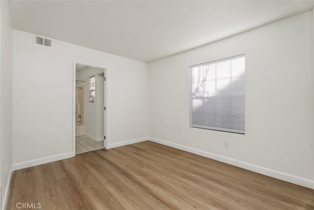 1044 Calle Del Cerro Unit 301, San Clemente, CA 92672 - spare room featuring light wood-style floors, baseboards, and visible vents