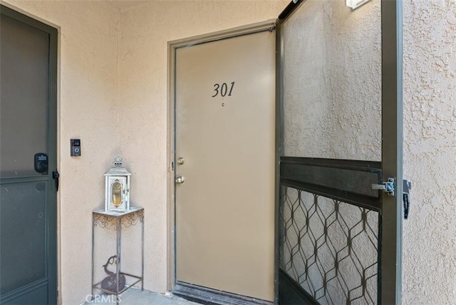 1044 Calle Del Cerro Unit 301, San Clemente, CA 92672 - view of exterior entry featuring stucco siding