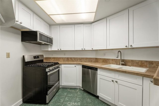 1044 Calle Del Cerro Unit 301, San Clemente, CA 92672 - kitchen with a sink, white cabinetry, and stainless steel appliances