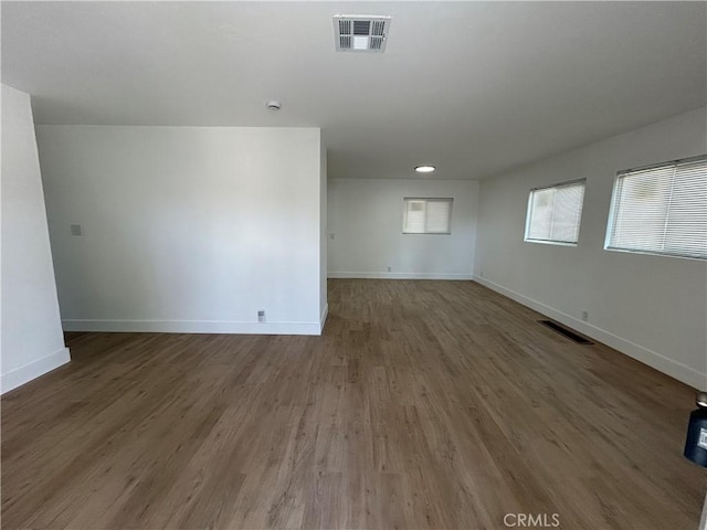 empty room featuring baseboards and visible vents