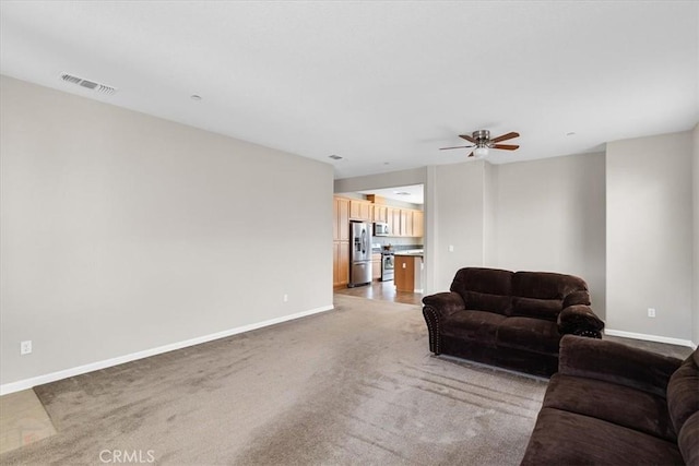 930 Travertine Way, Atwater, CA 95301 - living room with light colored carpet, ceiling fan, baseboards, and visible vents