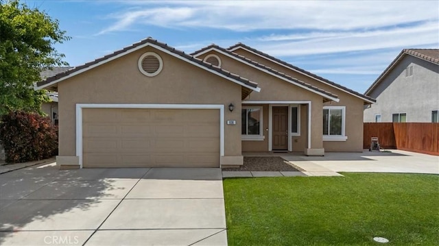 930 Travertine Way, Atwater, CA 95301 - ranch-style home featuring concrete driveway, a front lawn, fence, a garage, and stucco siding
