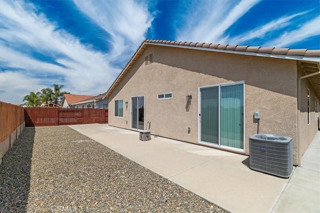 930 Travertine Way, Atwater, CA 95301 - back of property featuring central air condition unit, a patio, a fenced backyard, and stucco siding