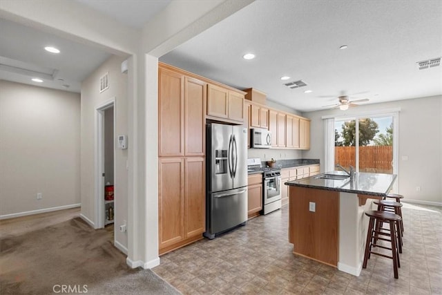 930 Travertine Way, Atwater, CA 95301 - kitchen with stainless steel appliances, baseboards, and visible vents