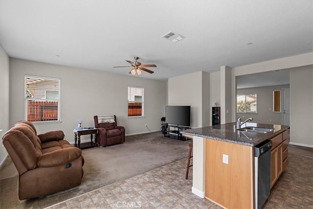 930 Travertine Way, Atwater, CA 95301 - kitchen with dishwashing machine, open floor plan, a sink, and a healthy amount of sunlight