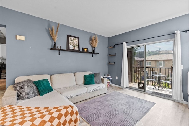 living area featuring wood finished floors and baseboards