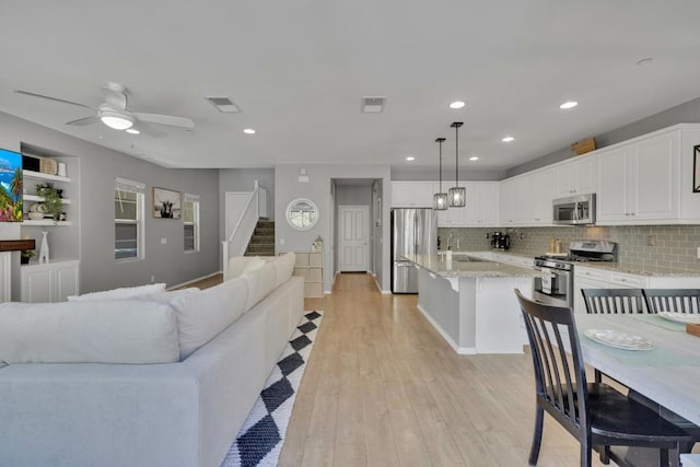 1132 Cherry Tree Ln, Vista, CA 92084 - living room with stairs, light wood-style flooring, recessed lighting, and ceiling fan