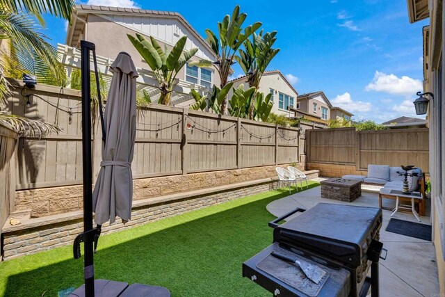 1132 Cherry Tree Ln, Vista, CA 92084 - fenced backyard featuring a fire pit and a patio area