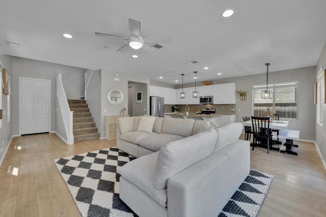 1132 Cherry Tree Ln, Vista, CA 92084 - living area featuring a ceiling fan, light wood-style flooring, recessed lighting, and stairs