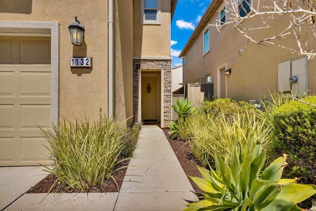 1132 Cherry Tree Ln, Vista, CA 92084 - view of exterior entry featuring stucco siding, stone siding, and a garage