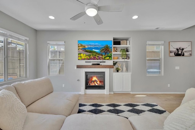 1132 Cherry Tree Ln, Vista, CA 92084 - living room featuring a glass covered fireplace, wood finished floors, recessed lighting, and ceiling fan